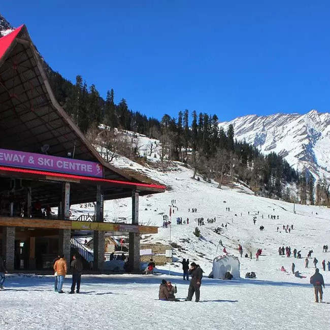 Snowy hill station with tourists on holiday